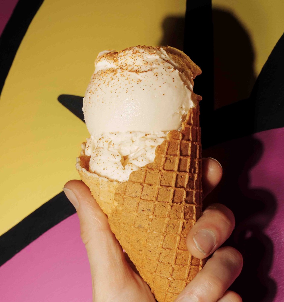 A cone in front of the Countertop Creamery logo wall