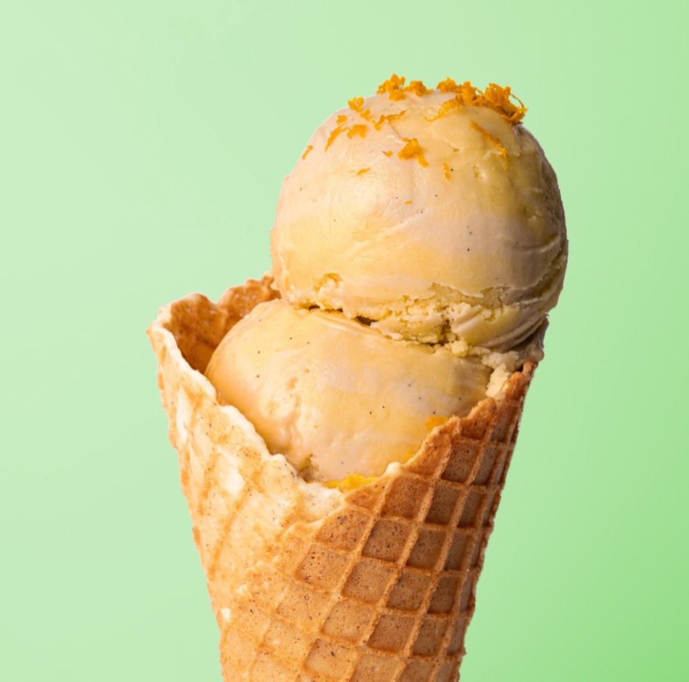 Bright orange scoop in a waffle cone