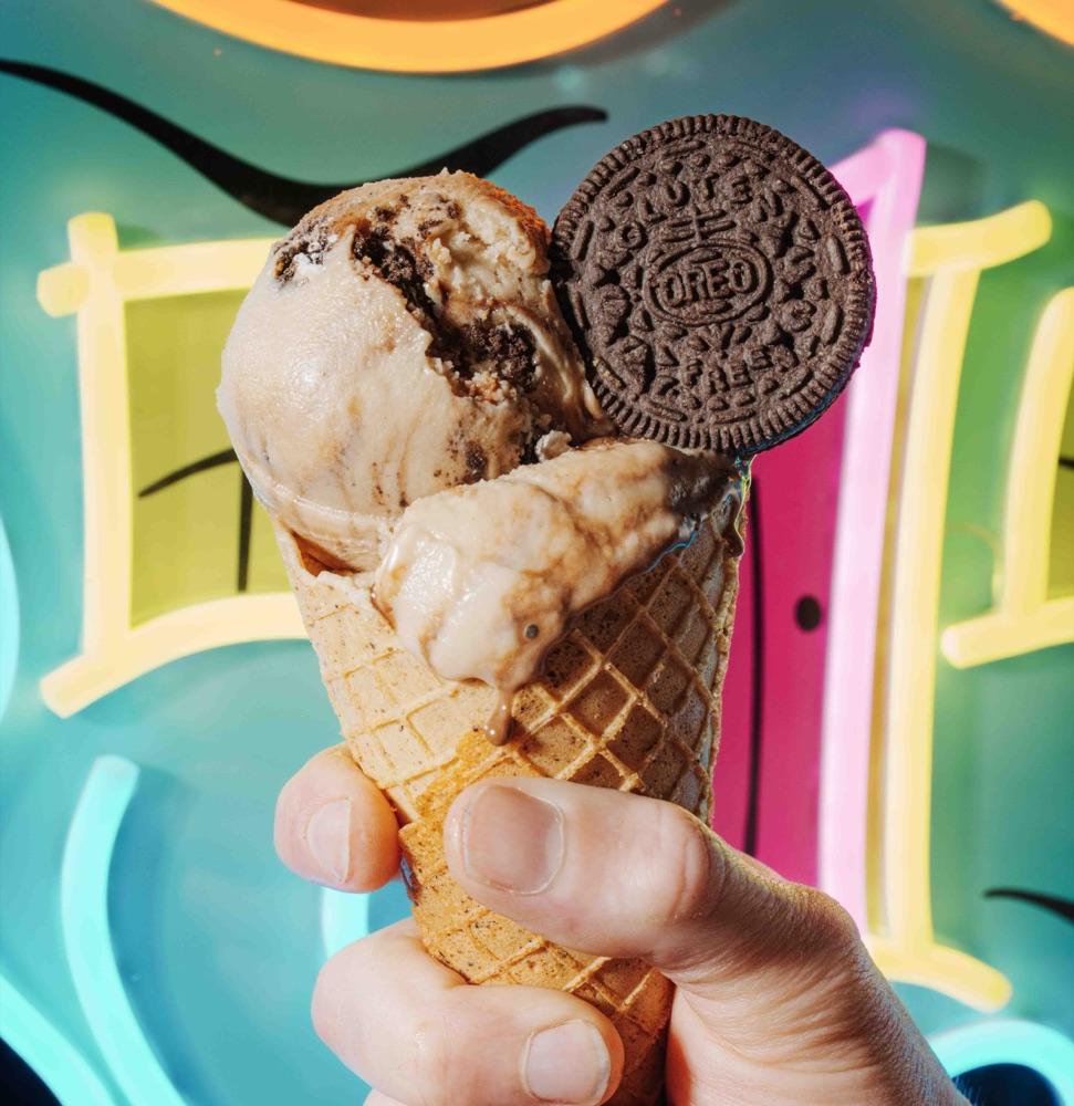 Cookies-and-cream cone against the neon sign